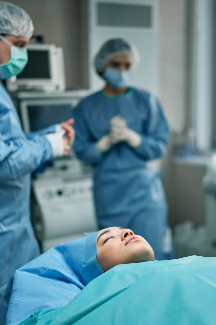 an unconscious female patient lying on an operating table